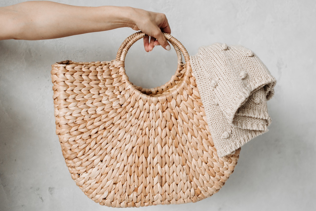 hand holding basket with knitted blanket