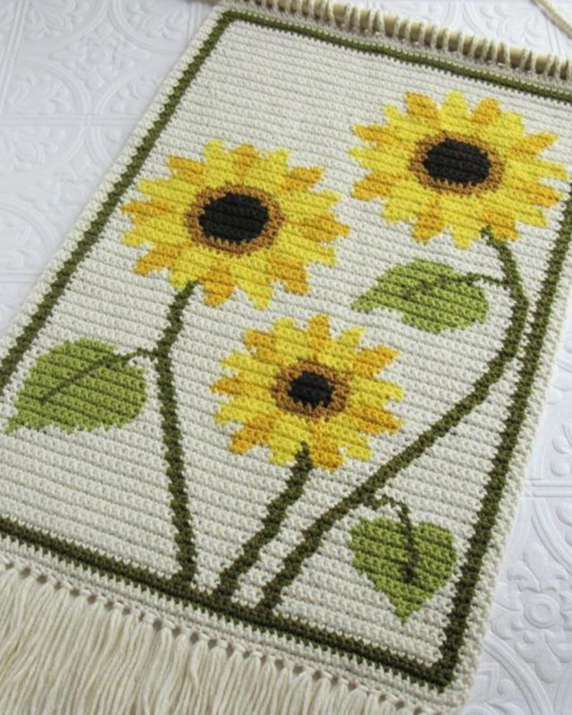 white, yellow, and green wall hanging of sunflowers