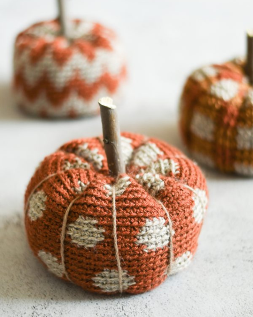 three orange and tan crochet pumpkins with different patterns