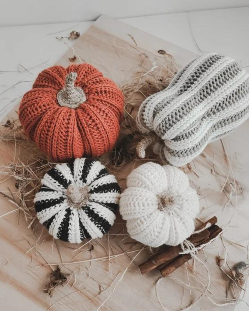 four crochet pumpkins of various size, shape, and color