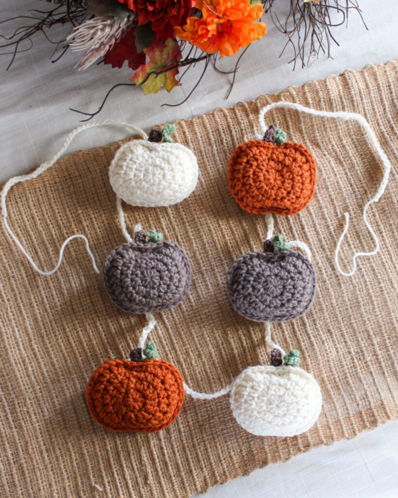 white, grey, and orange pumpkin amigurumi garland