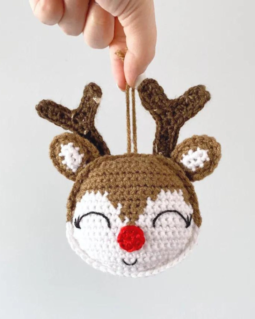 hand holding crochet amigurumi reindeer ornament