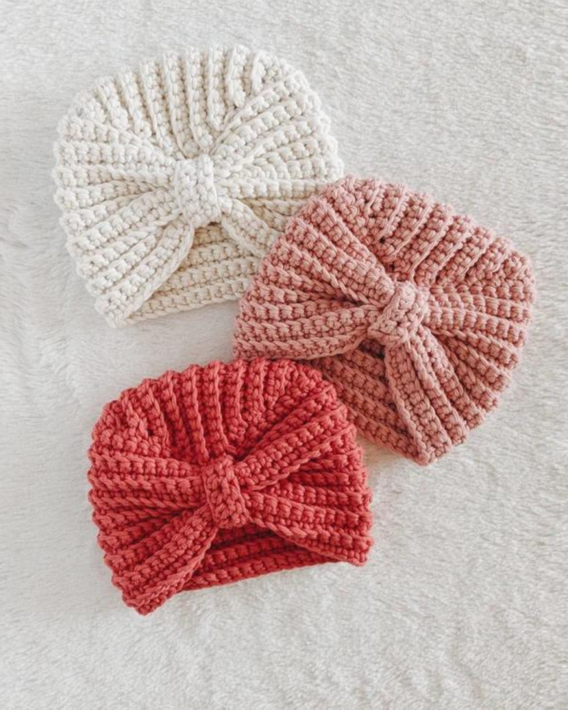 three crochet baby hats