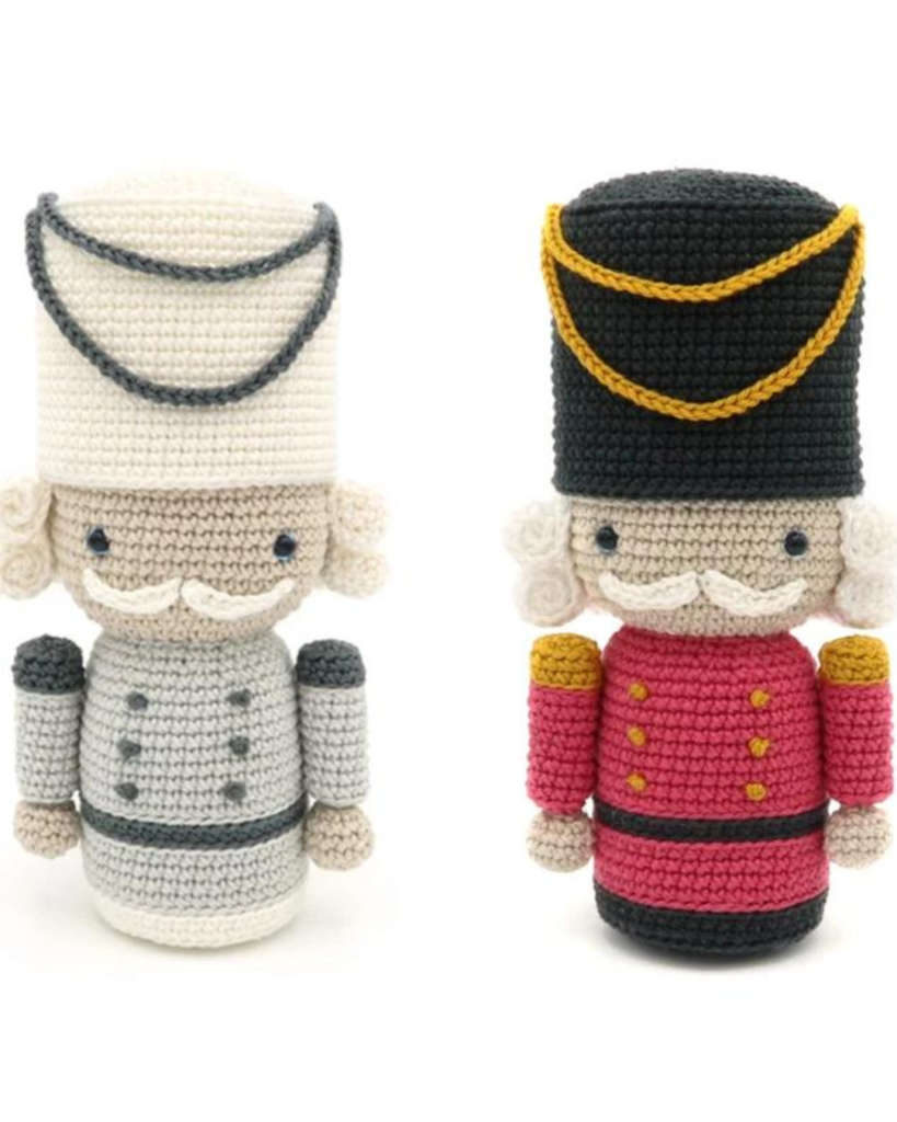 two crochet amigurumi nutcracker soldiers