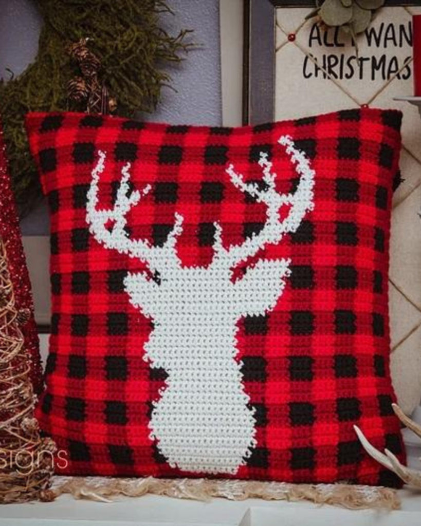 red and black crochet plaid pillow case with white reindeer silhouette