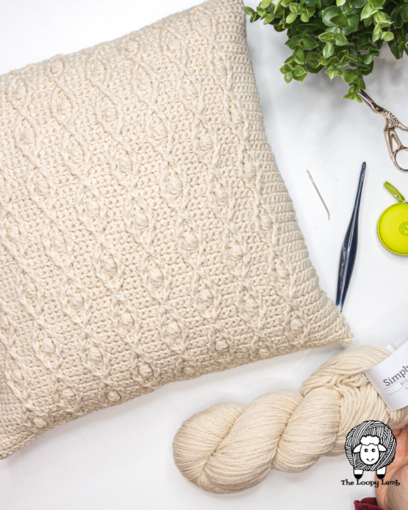 crochet cream pillow cover with bobbles and cable stitch