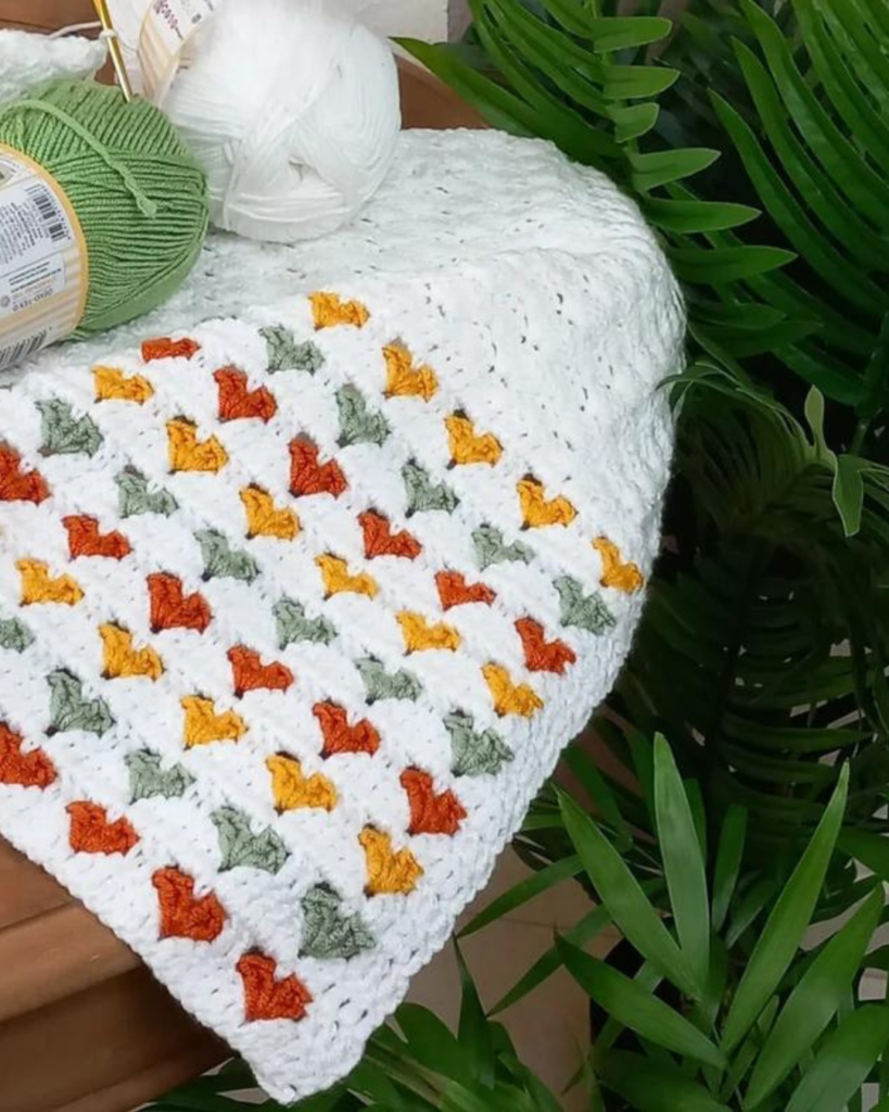 multicolor crochet hearts on white blanket