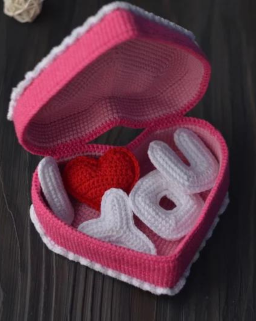 pink crochet heart box with amigurumi "i heart you" letters