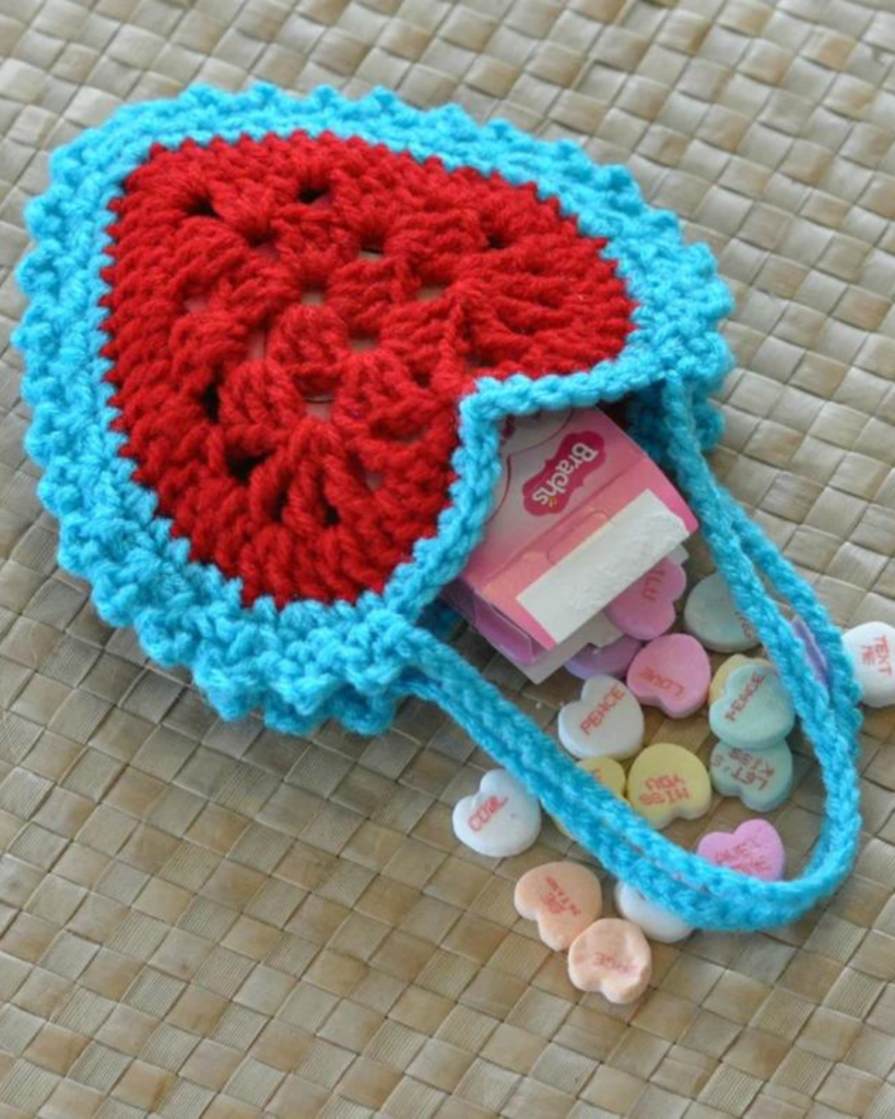 blue and red heart-shaped bag with heart candies inside