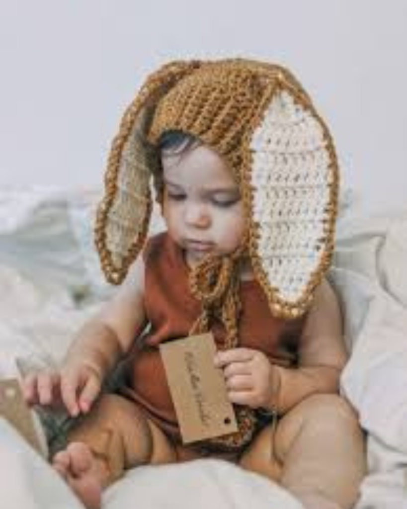 baby wearing crochet hat with bunny ears