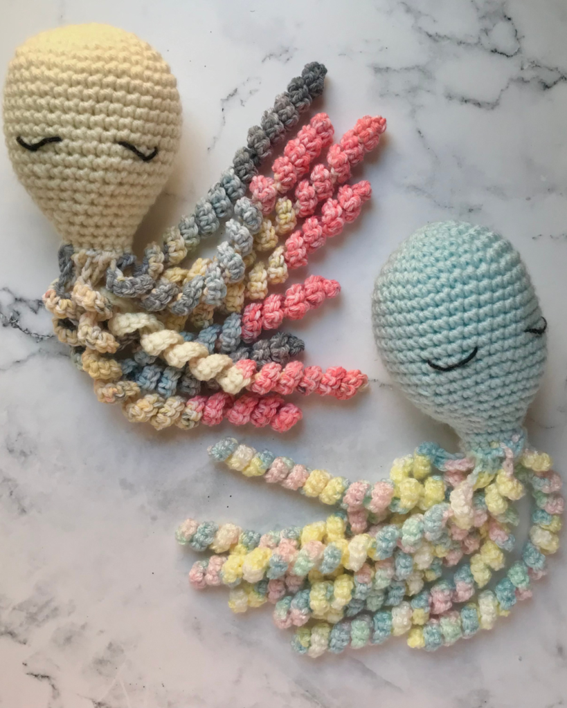 two crochet amigurumi octopi