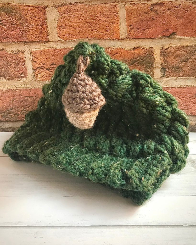 green crochet puff stitch hat with acorn