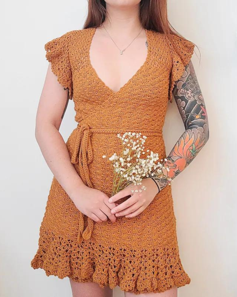 woman wearing orange crochet wrap dress
