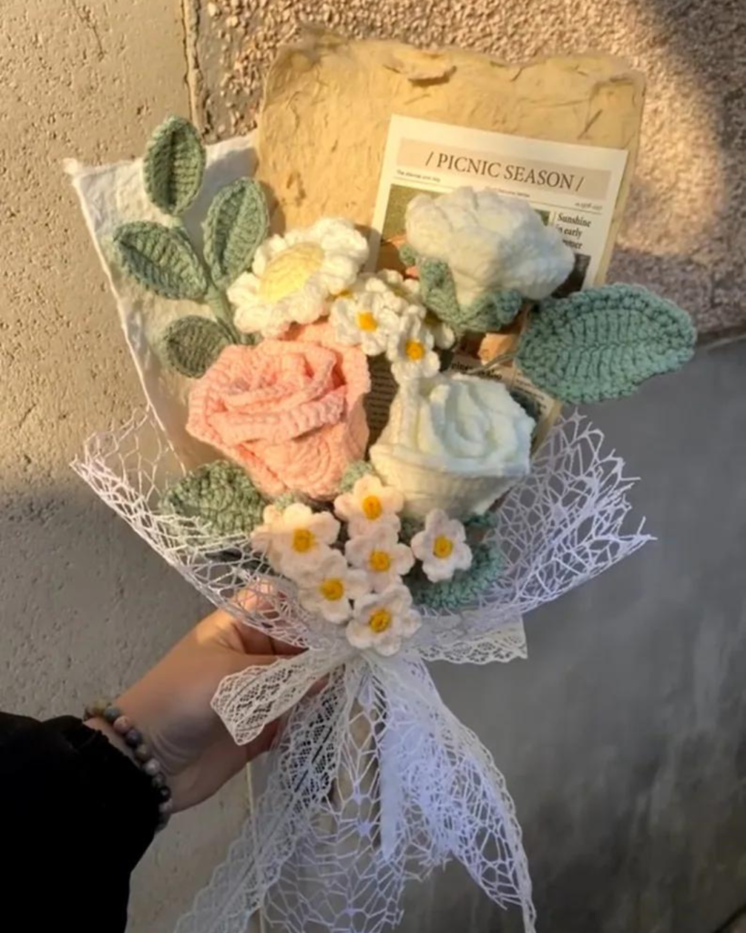 hand holding bouquet of 3D crochet flowers