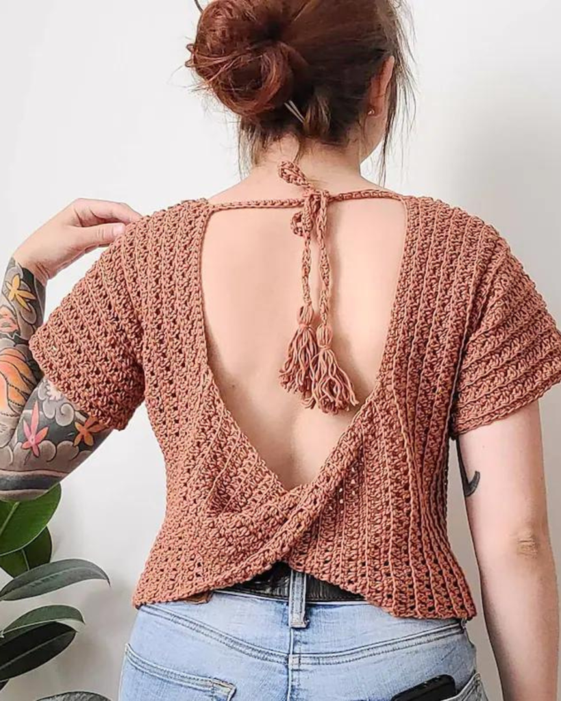 woman wearing pink crochet open back top