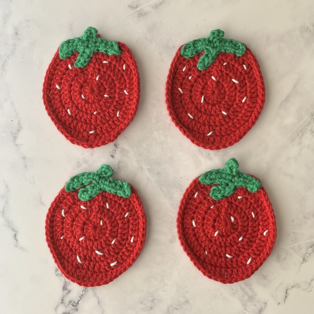 four red strawberry crochet coasters