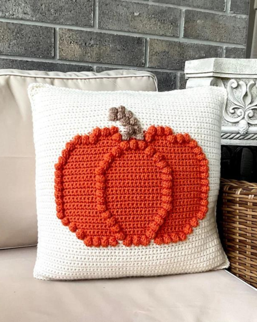 white crochet pillow with orange bobble pumpkin