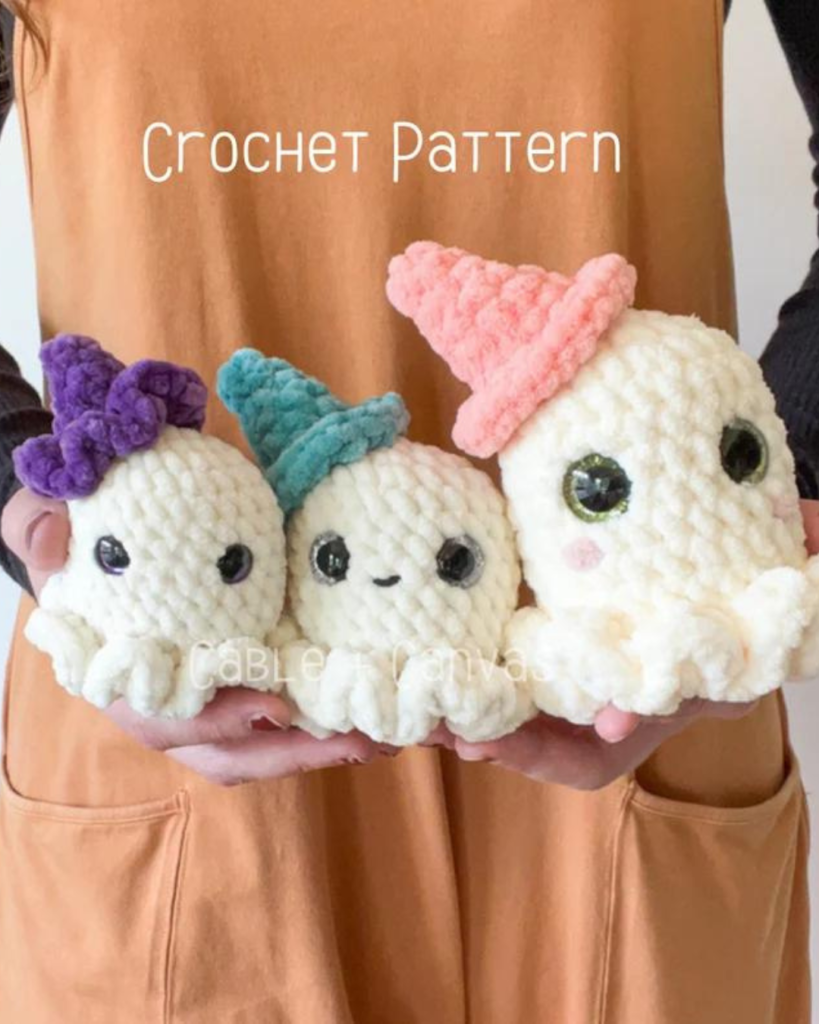 three crochet chunky yarn ghosts with hats