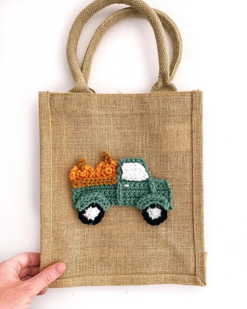 brown canvas bag with crochet truck with pumpkins applique