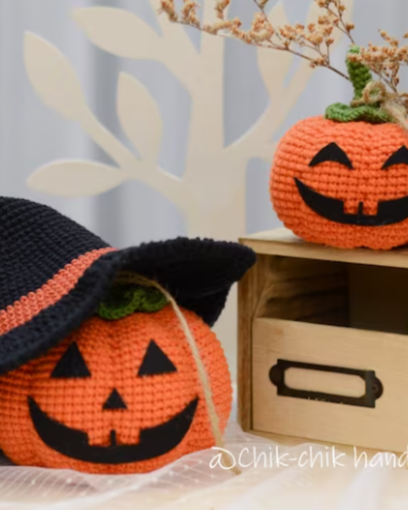 two crochet jack-o-lantern pumpkins