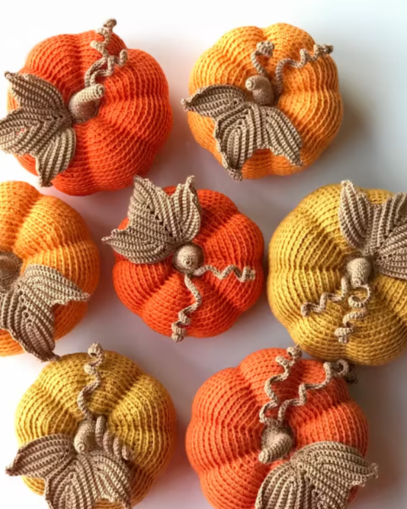 seven crochet pumpkins in various colors