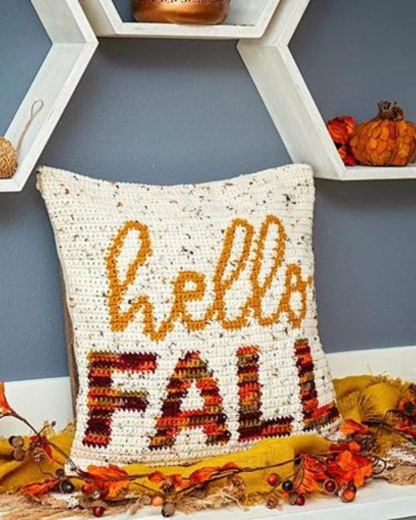 white speckled crochet pillow with phrase "hello fall"