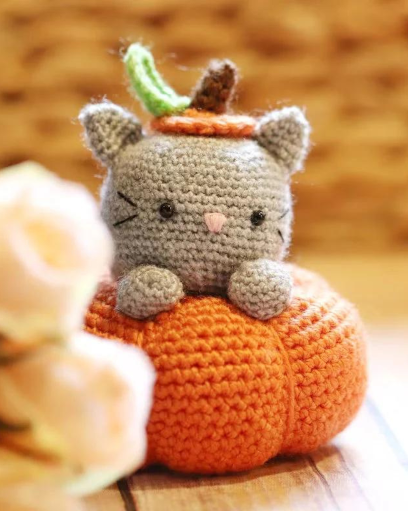 crochet amigurumi kitten popping out of crochet pumpkin