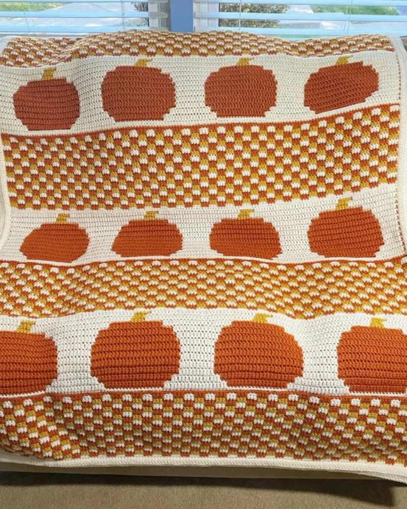 crochet orange pumpkin and plaid blanket