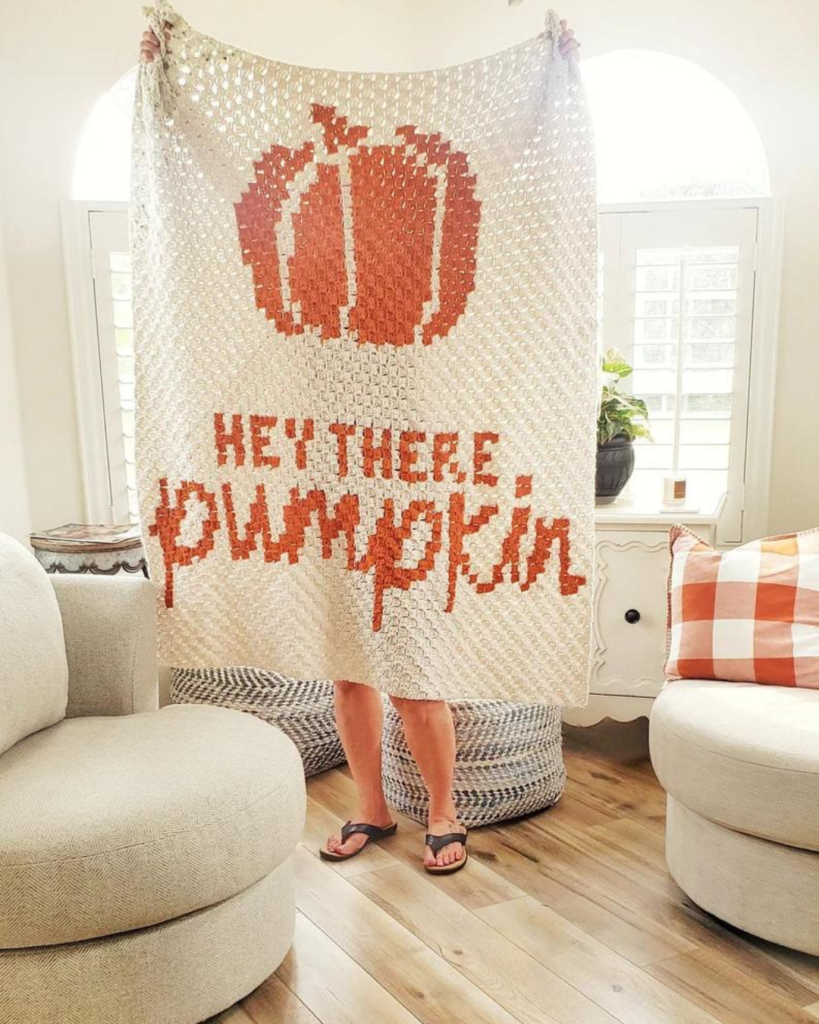 white crochet corner to corner blanket with orange pumpkin and phrase "hey there, pumpkin"