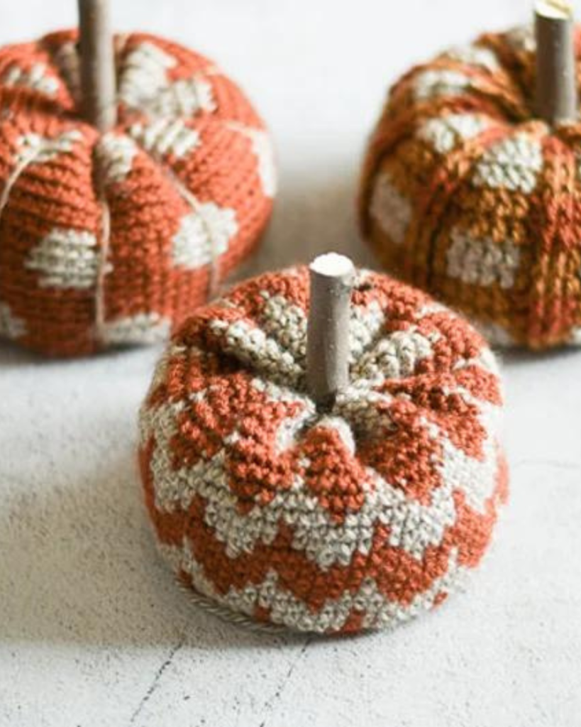 three crochet pumpkins with different patterns