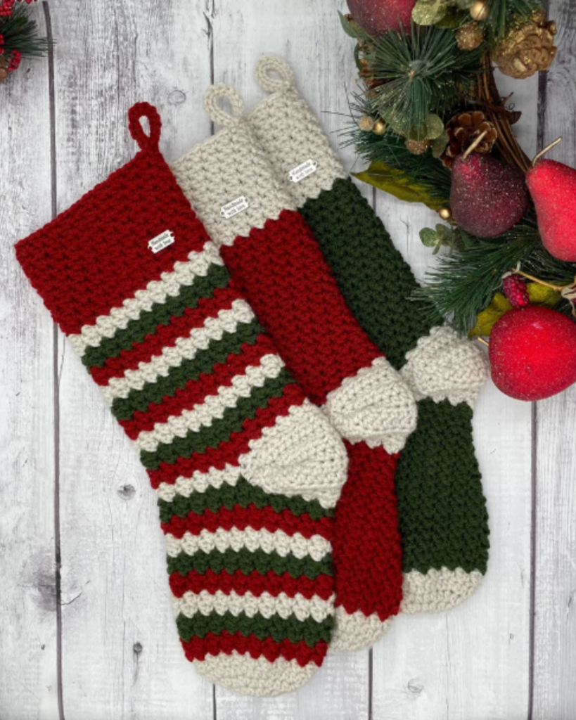 three crochet christmas stockings of various colors