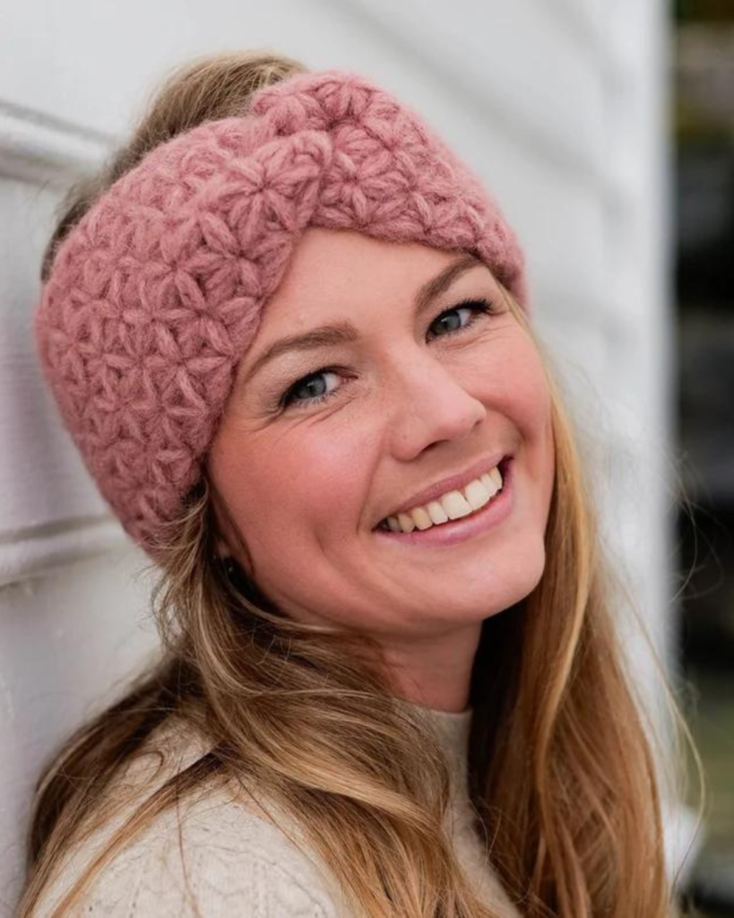 woman wearing pink crochet ear warmer
