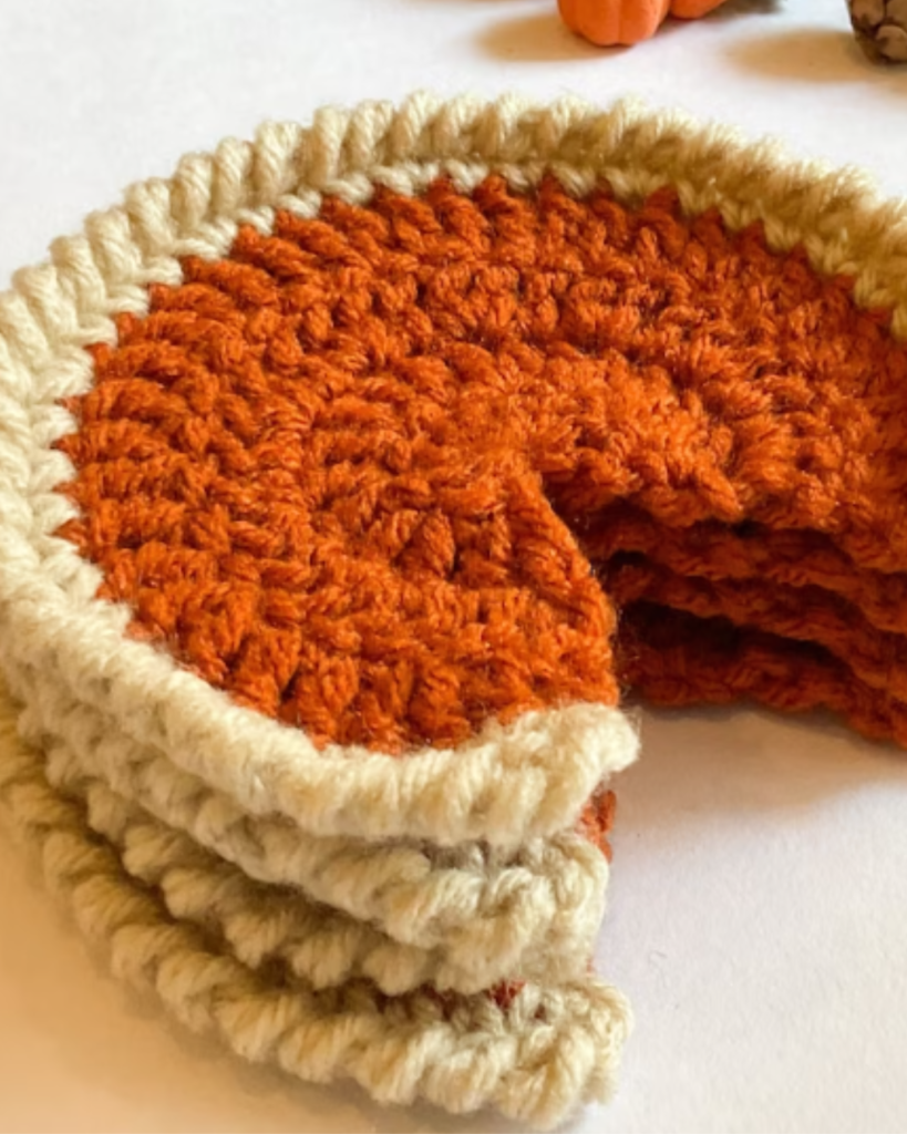 multiple crochet pumpkin pie coasters with slice missing