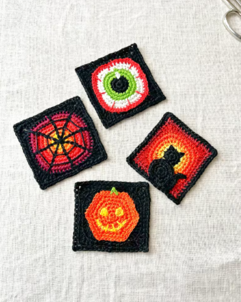 four crochet halloween decor squares with various designs