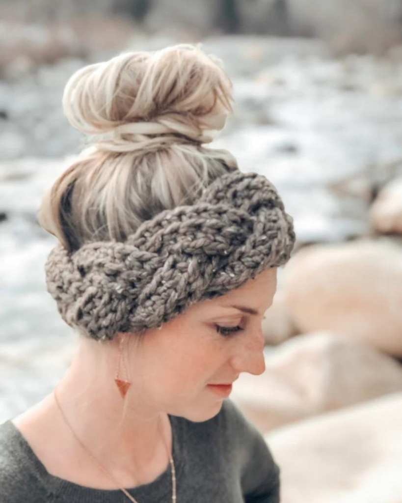 woman wearing grey braided crochet ear warmer