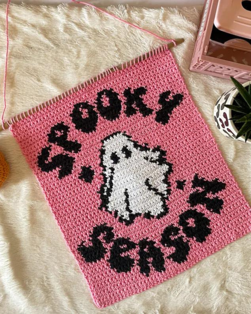 pink wallhanging with ghost and phrase "spooky season"