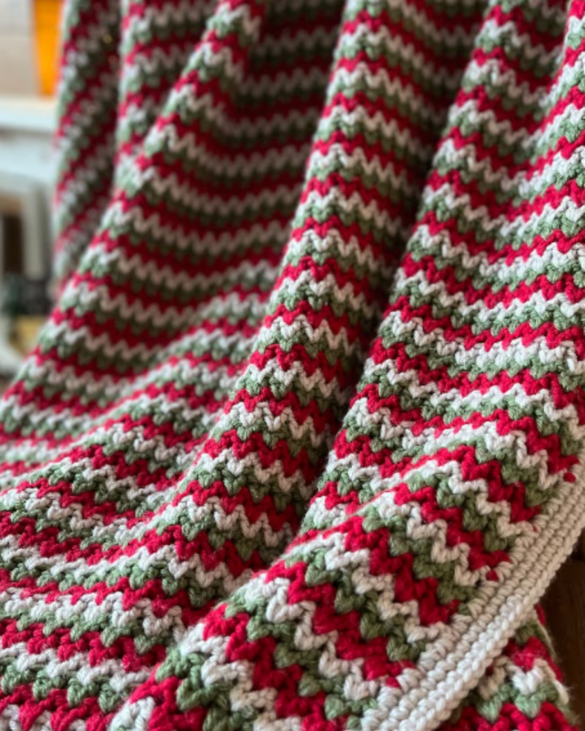 red, green, and white zig zag striped crochet blanket