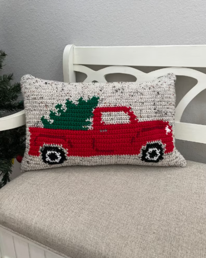 multicolor crochet pillow with truck and tree design