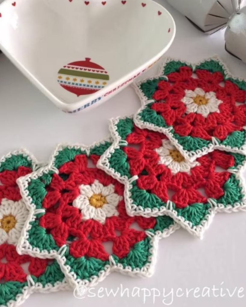 four crochet poinsettia coasters