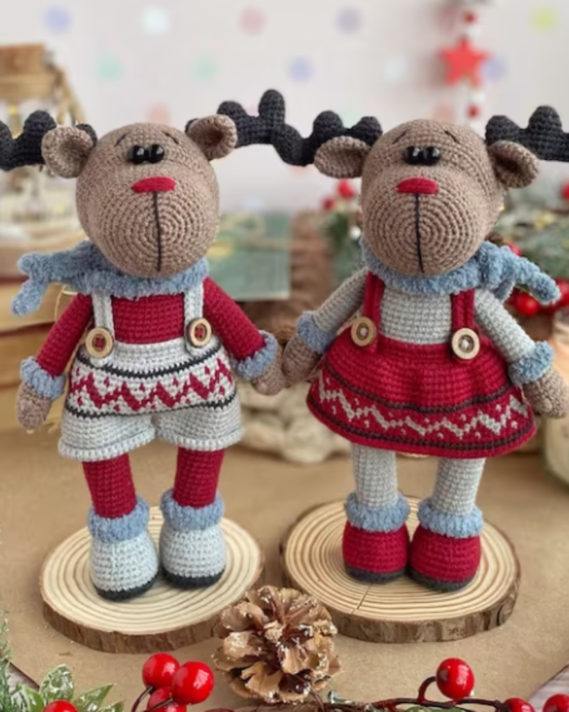 two crochet moose wearing overalls