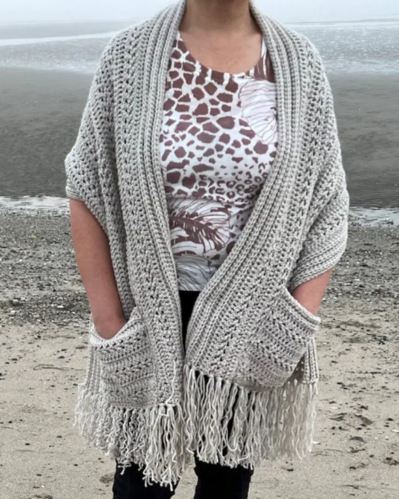 grey crochet pocket shawl with tassels