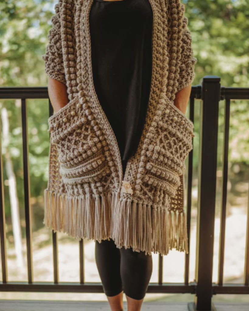 tan brown crochet pocket shawl with bobble stitches and tassels