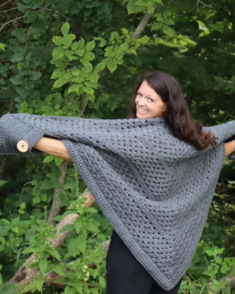 grey triangular crochet pocket shawl with buttons