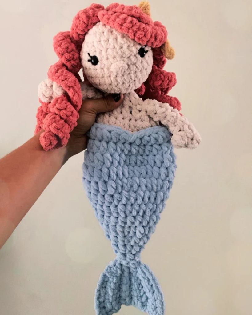 hand holding mermaid crochet snuggler
