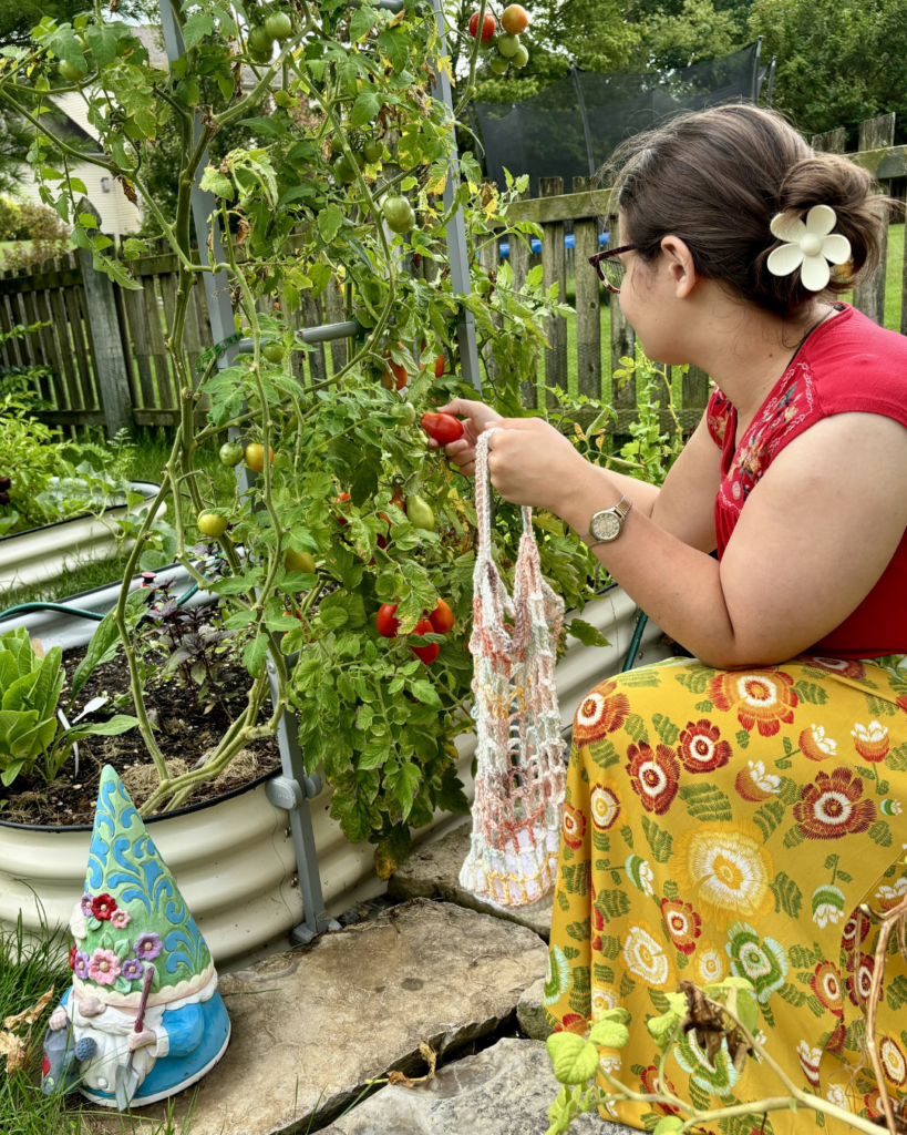 woman using crochet market bag to pick vegetables