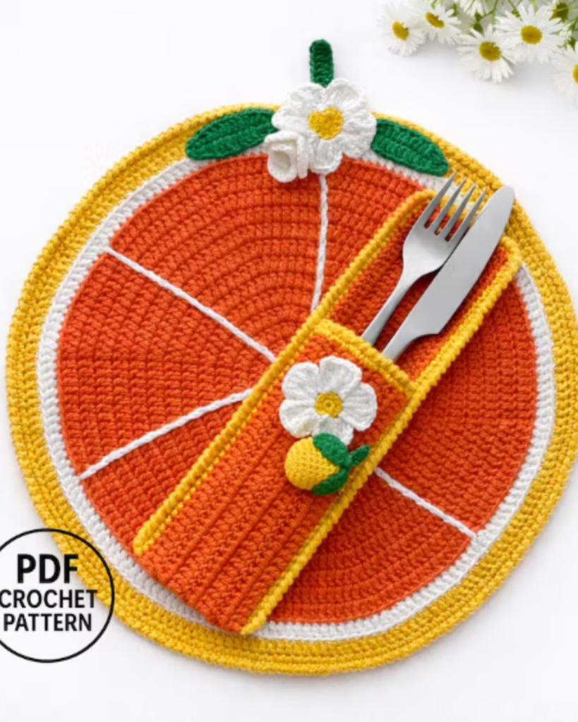 Handmade crochet placemat with orange and flower design