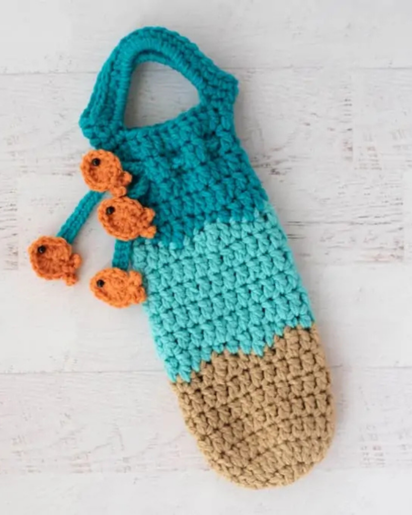 Beach-themed crochet wine bottle holder designed for gifting or carrying a bottle
