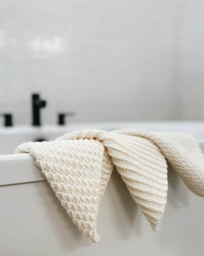 Crochet dishcloth made with textured stitches in a neutral cotton yarn