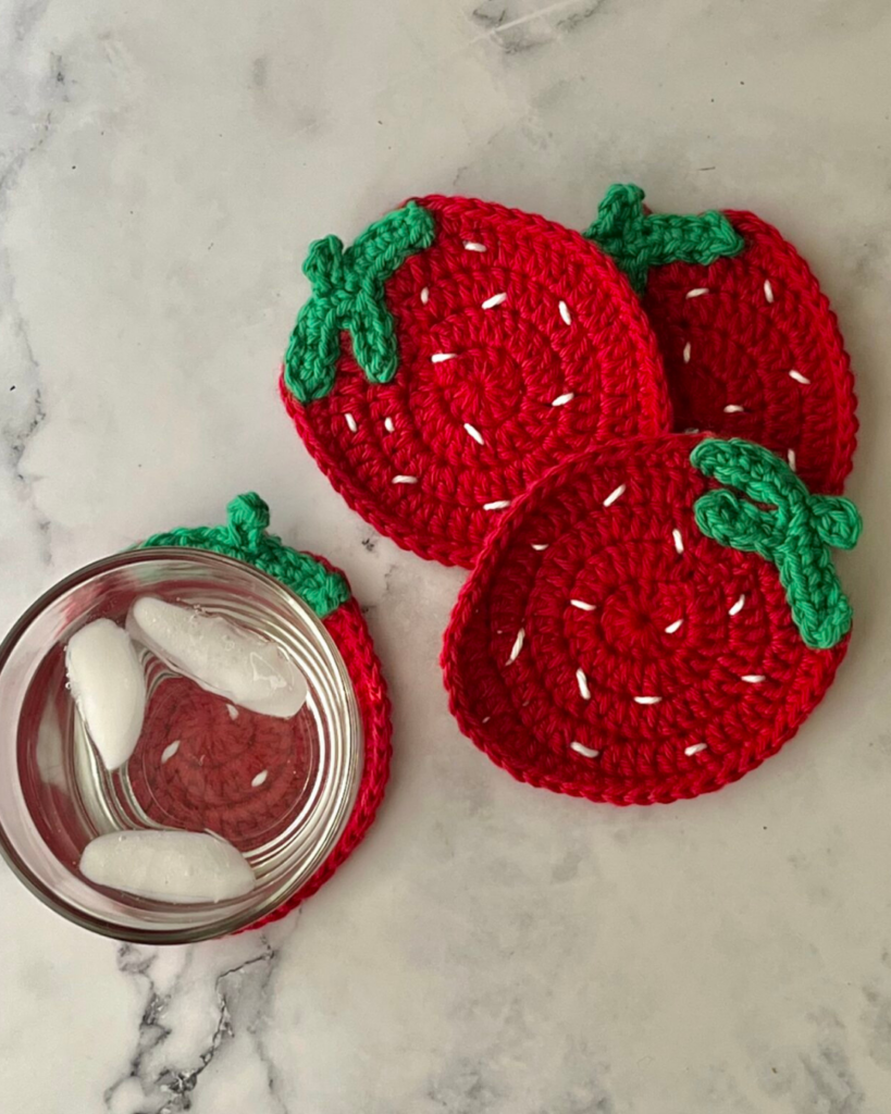 Set of strawberry crochet coasters made with simple beginner-friendly stitches