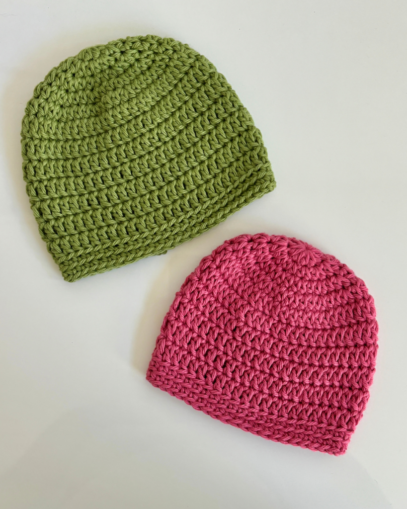 close up of crochet baby hats before butterfly applique is attached